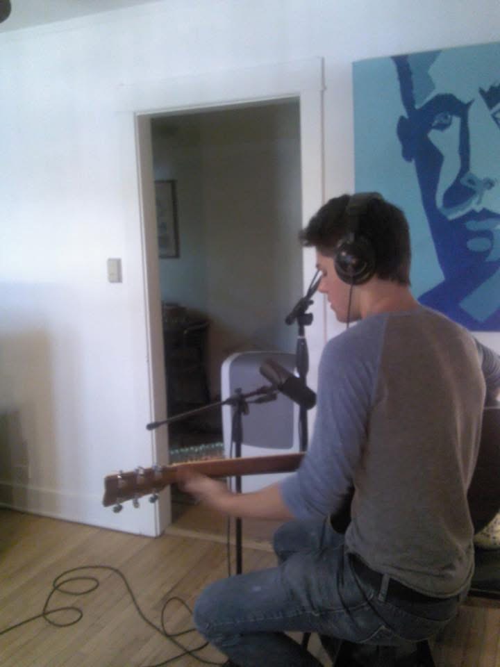 Julius Cole Rassin recording at home in headphones