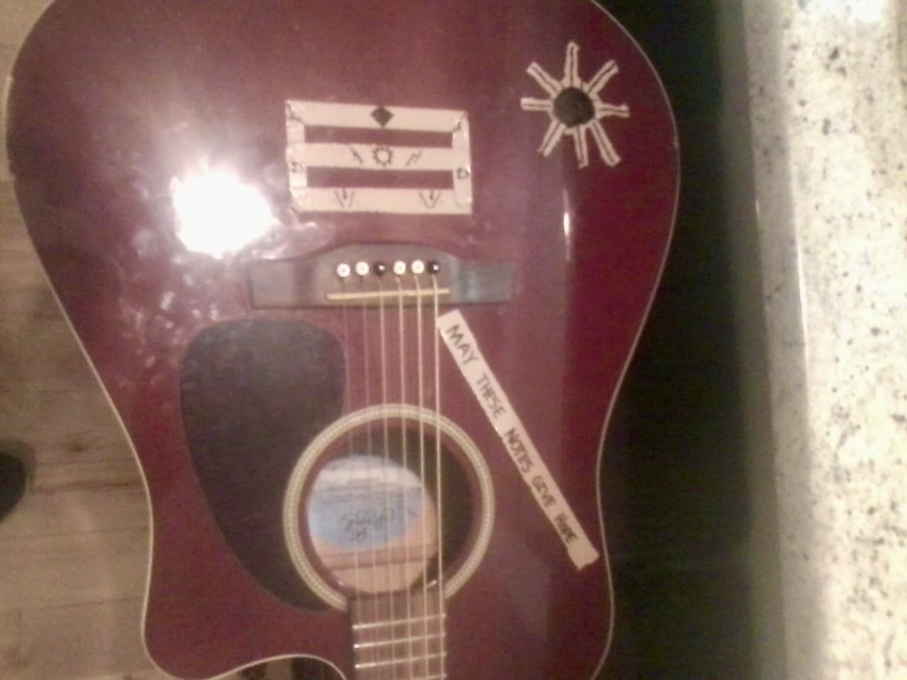 Julius Cole Rassin's guitar with a handwritten note, may these notes give hope