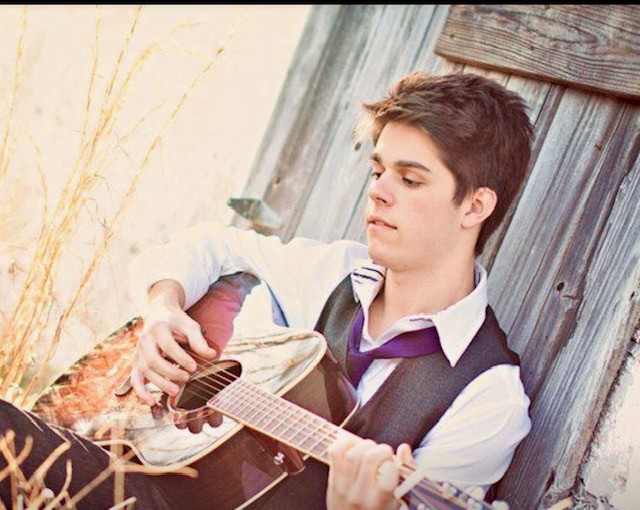 Julius Cole Rassin with his acoustic guitar, early 2010s portrait